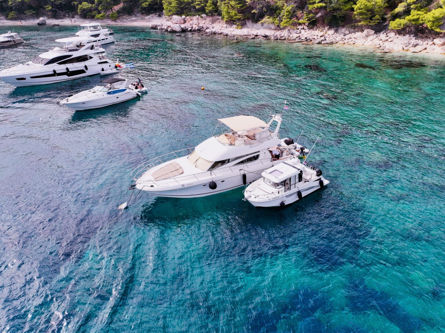 Motor yacht and speedboat anchored in clear Adriatic waters