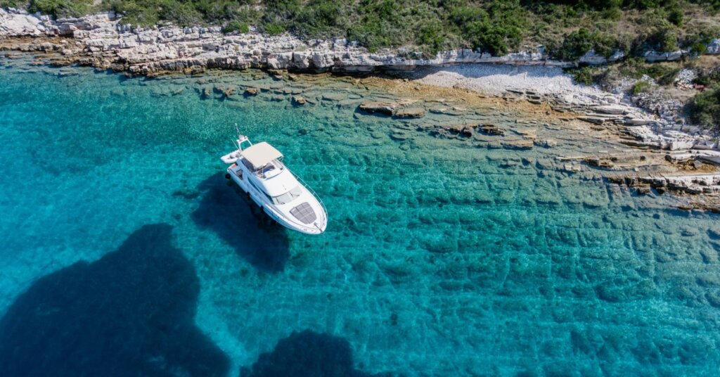 Luxury yacht anchored in crystal-clear Adriatic waters along the Croatian coast