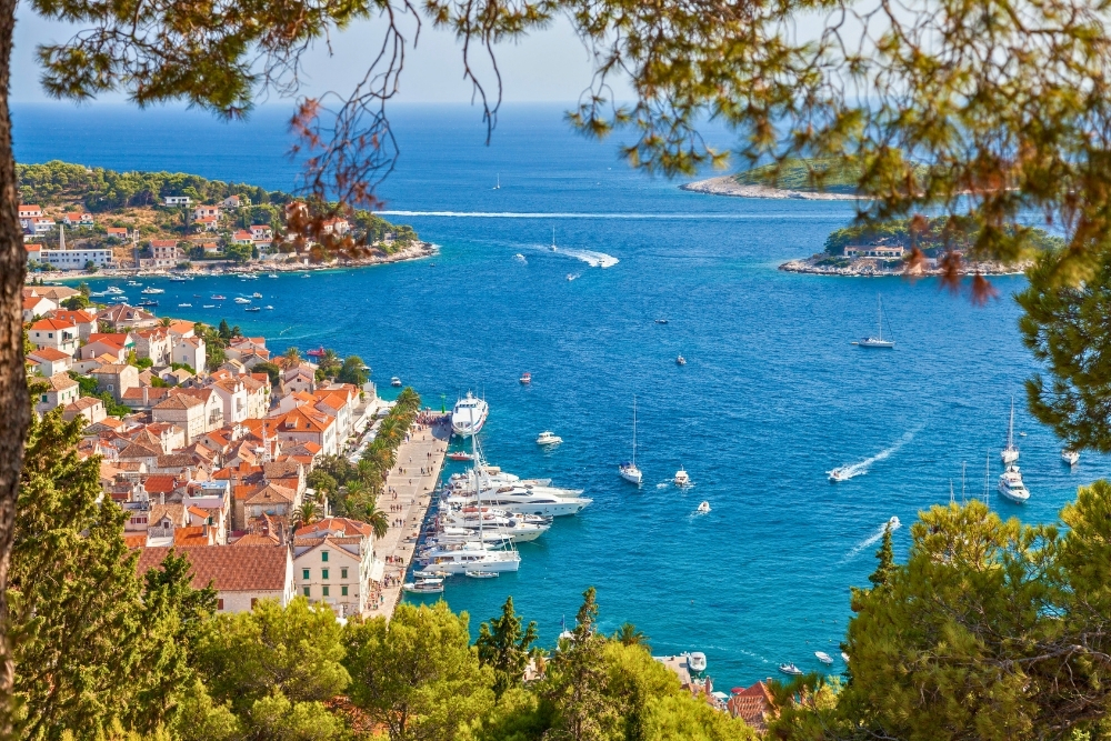 Luxury yachts in Hvar harbor with view of Pakleni Islands Croatia