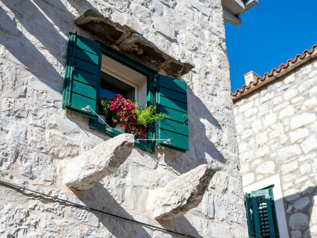 Traditional stone house with green shutters in Split Croatia