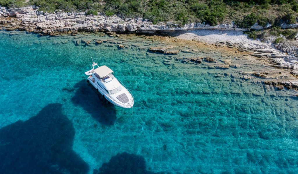Luxury yacht anchored in crystal-clear Adriatic waters along the Croatian coast
