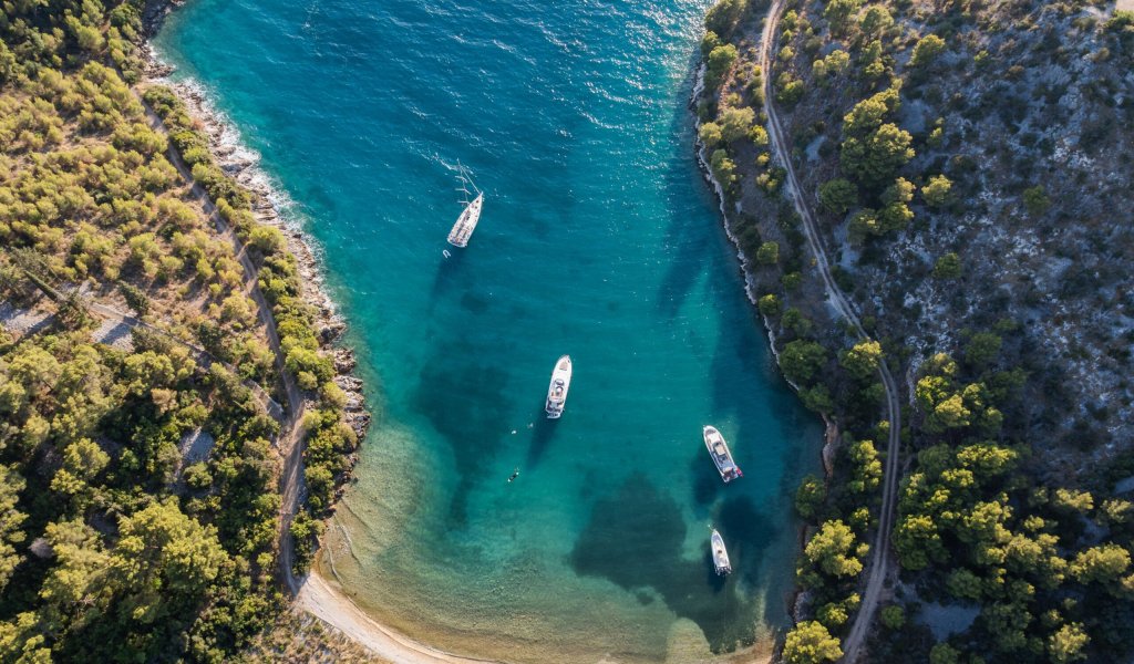 Yacht cruising through turquoise bays of the Adriatic Sea
