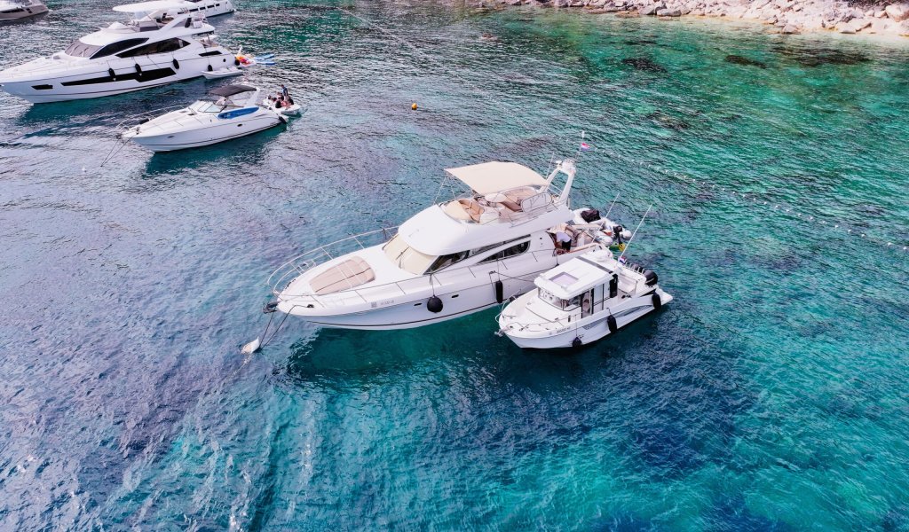Motor yacht and speedboat anchored in clear Adriatic waters